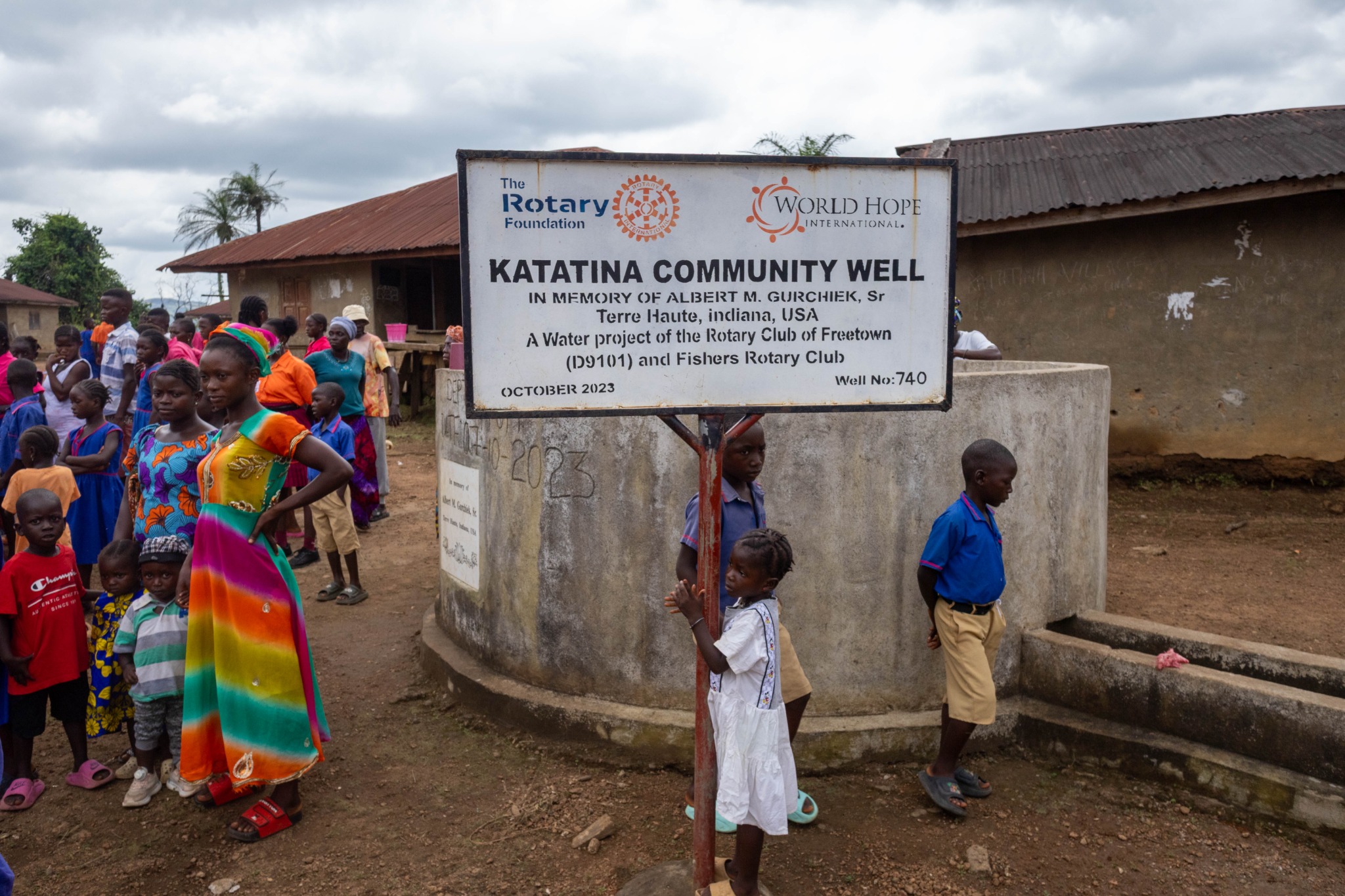 Children and adults gathered around the Katatina Community Well in Sierra Leone