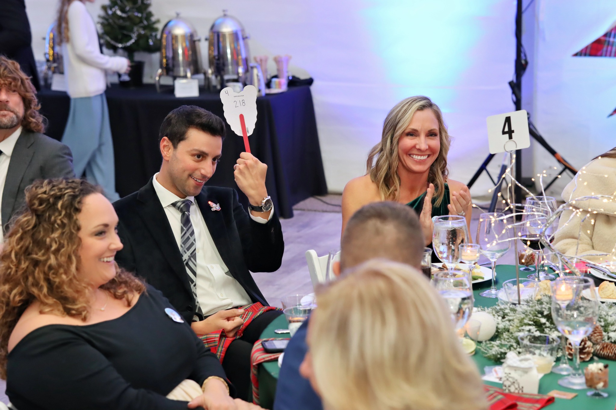 Guests smiling, applauding, and joining the auction at the 2025 WaterIsLife Charity Ball