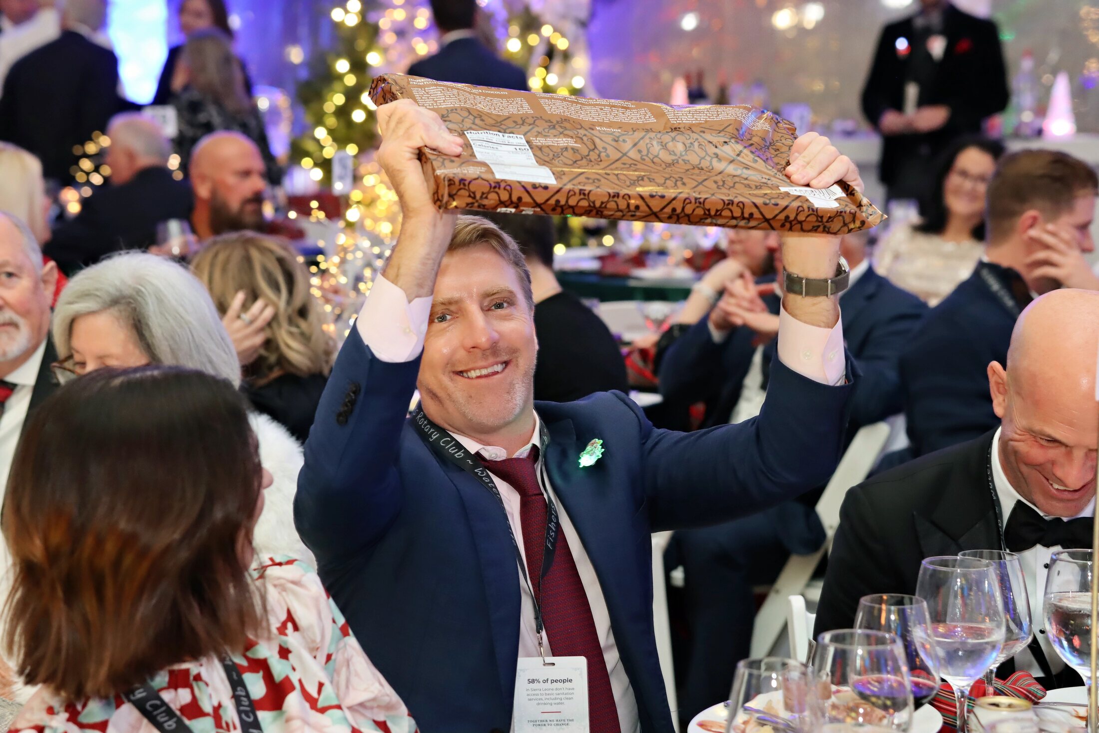 A guest celebrating an auction win at the 2025 Charity Ball