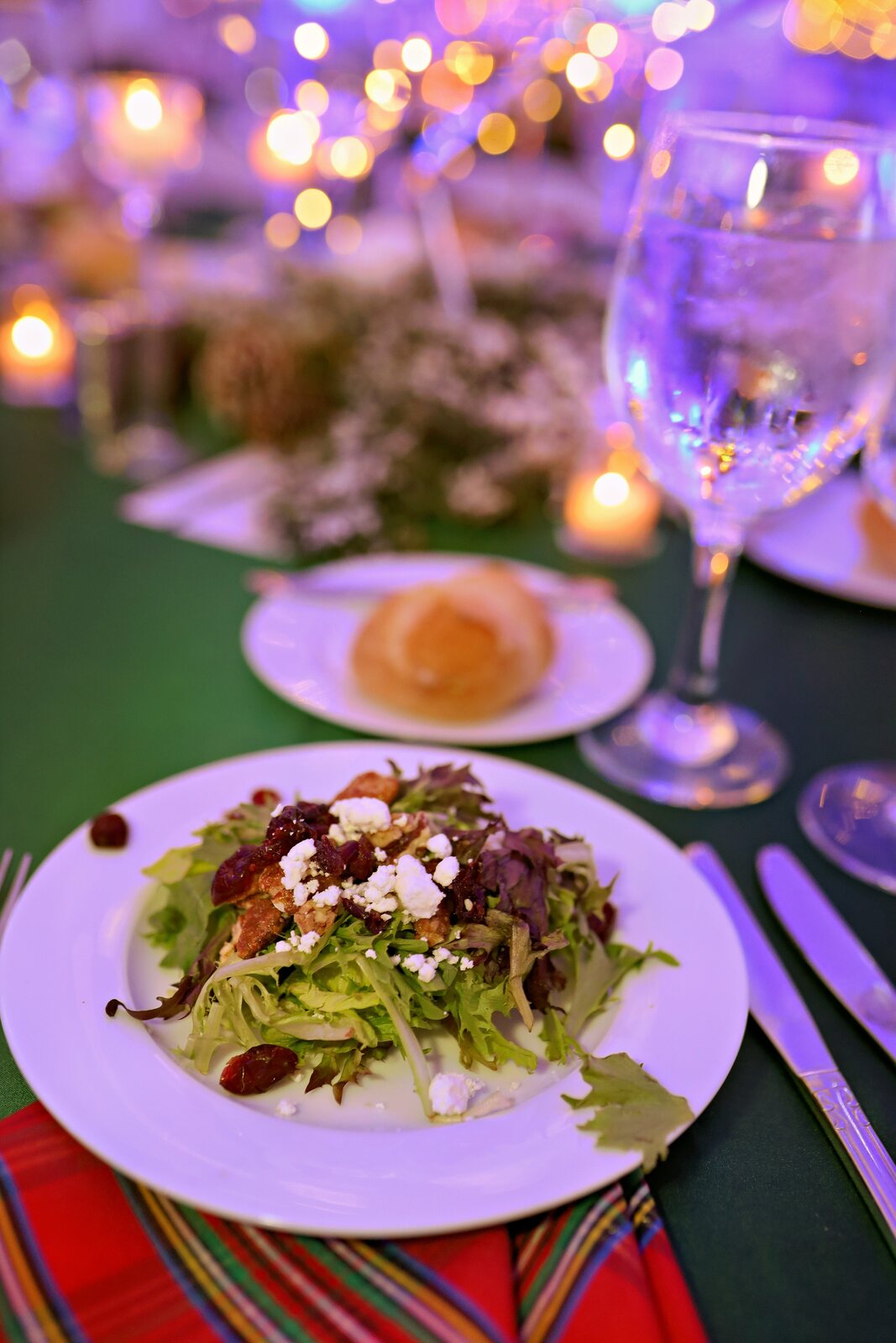 A place setting glowing beneath the lights of the WaterIsLife Charity Ball